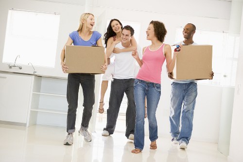 Removal truck and moving team near a suburban Highbury home