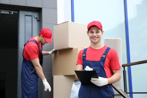 Removalists loading boxes and furniture for a residential move