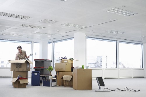 Staff preparing labelled boxes and IT items for office removals